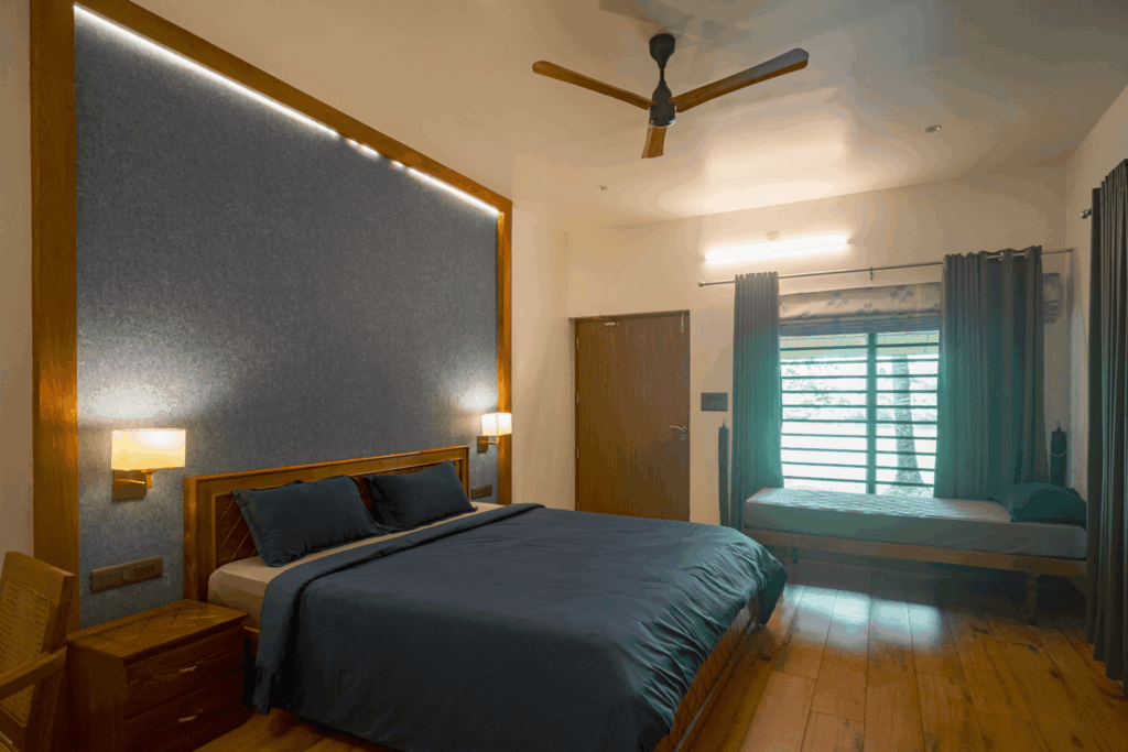 Bedroom in Kanikonna villa at Giby Farm with blue shutters and garden light
