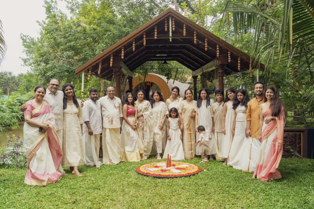 Family in traditional Kerala attire at a ceremony in the pavilion at Giby Farm