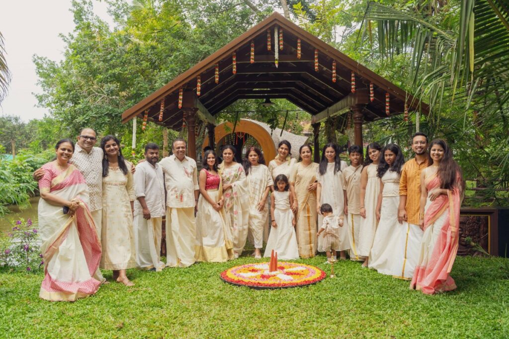 Family in traditional Kerala attire gathered at the pavilion for a ceremony at Giby Farm