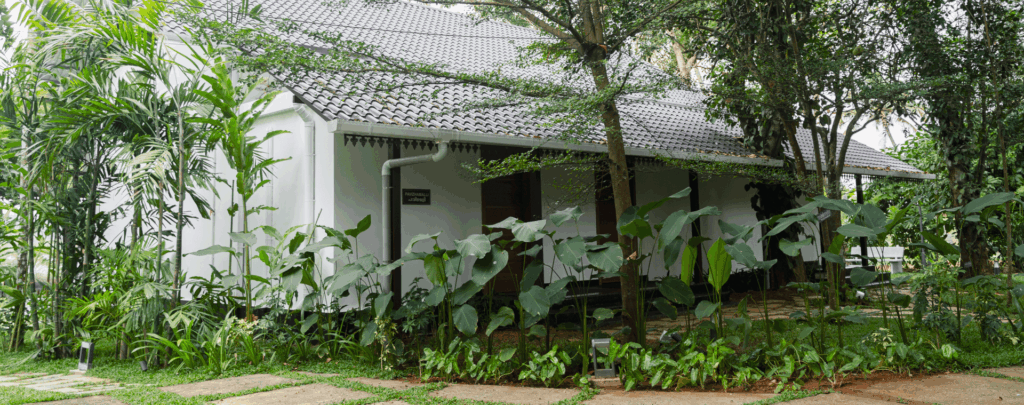 Pavizhamalli riverside villa at Giby Farm surrounded by trees and lawn