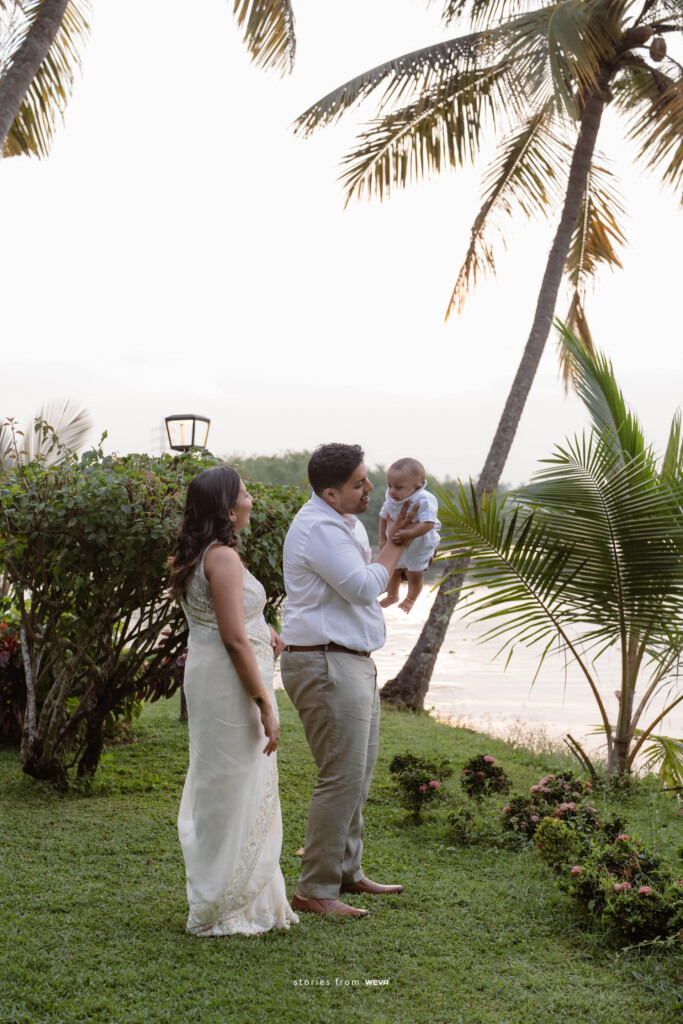 Couple with their child on the lawn among the palms at Giby Farm
