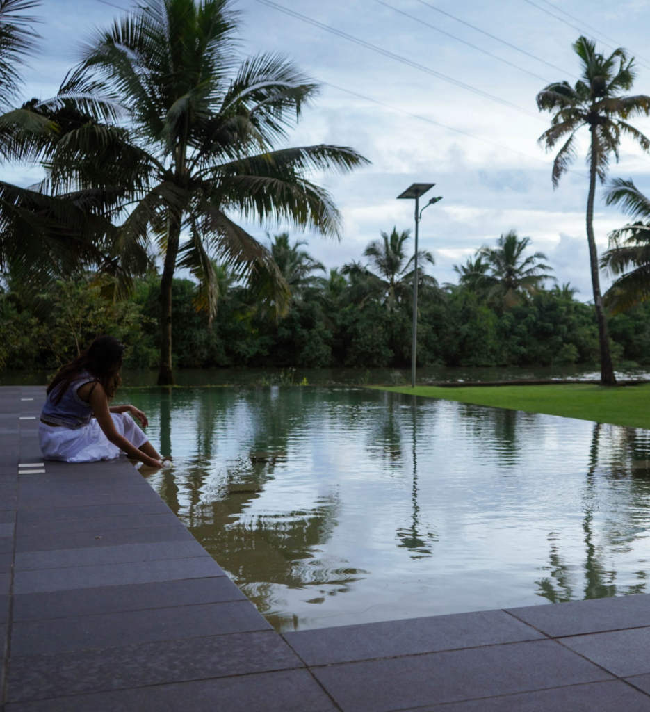Guest by the water edge among the coconut palms at Giby Farm
