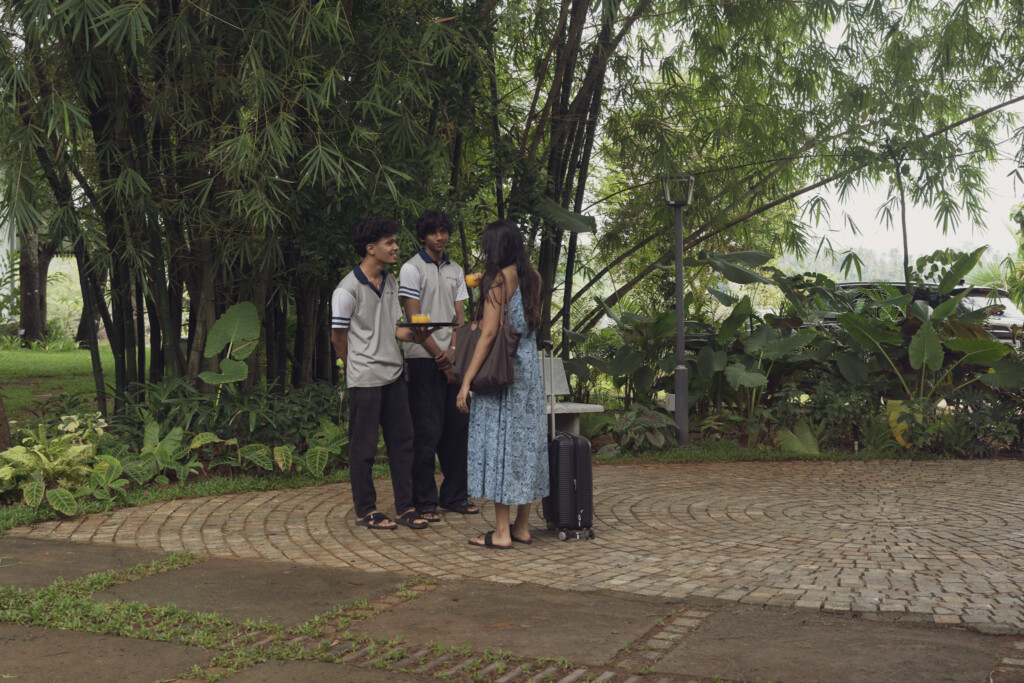 Family arriving with their luggage along the garden path at Giby Farm