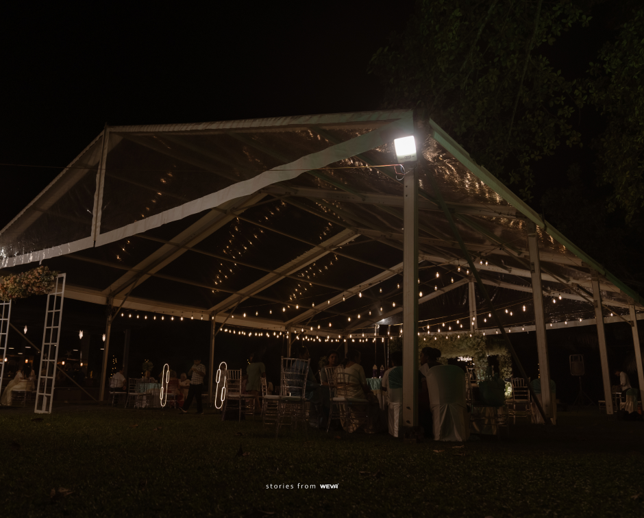 Illuminated wedding marquee on the lawn at Giby Farm at night
