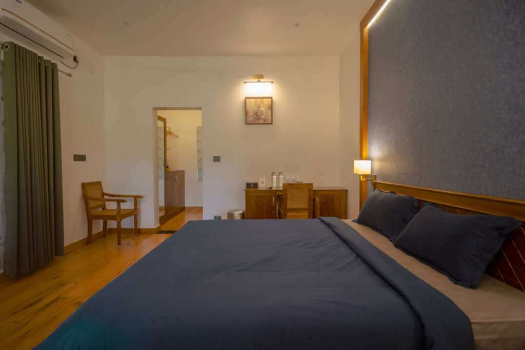 Twin bedded room in Kanikonna villa at Giby Farm with a seating corner