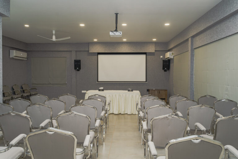 Conference room set with chairs and a projector screen at Giby Farm