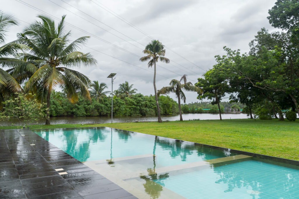 Swimming pool at Giby Farm looking out over the backwater and palms