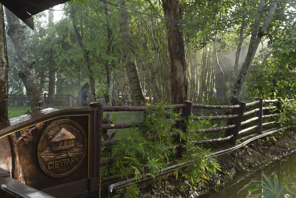 Wooden Giby Farm signboard in the garden by the entrance