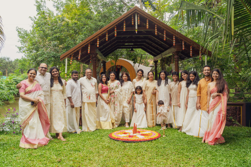 Guests in traditional Kerala attire gathered for a celebration at Giby Farm