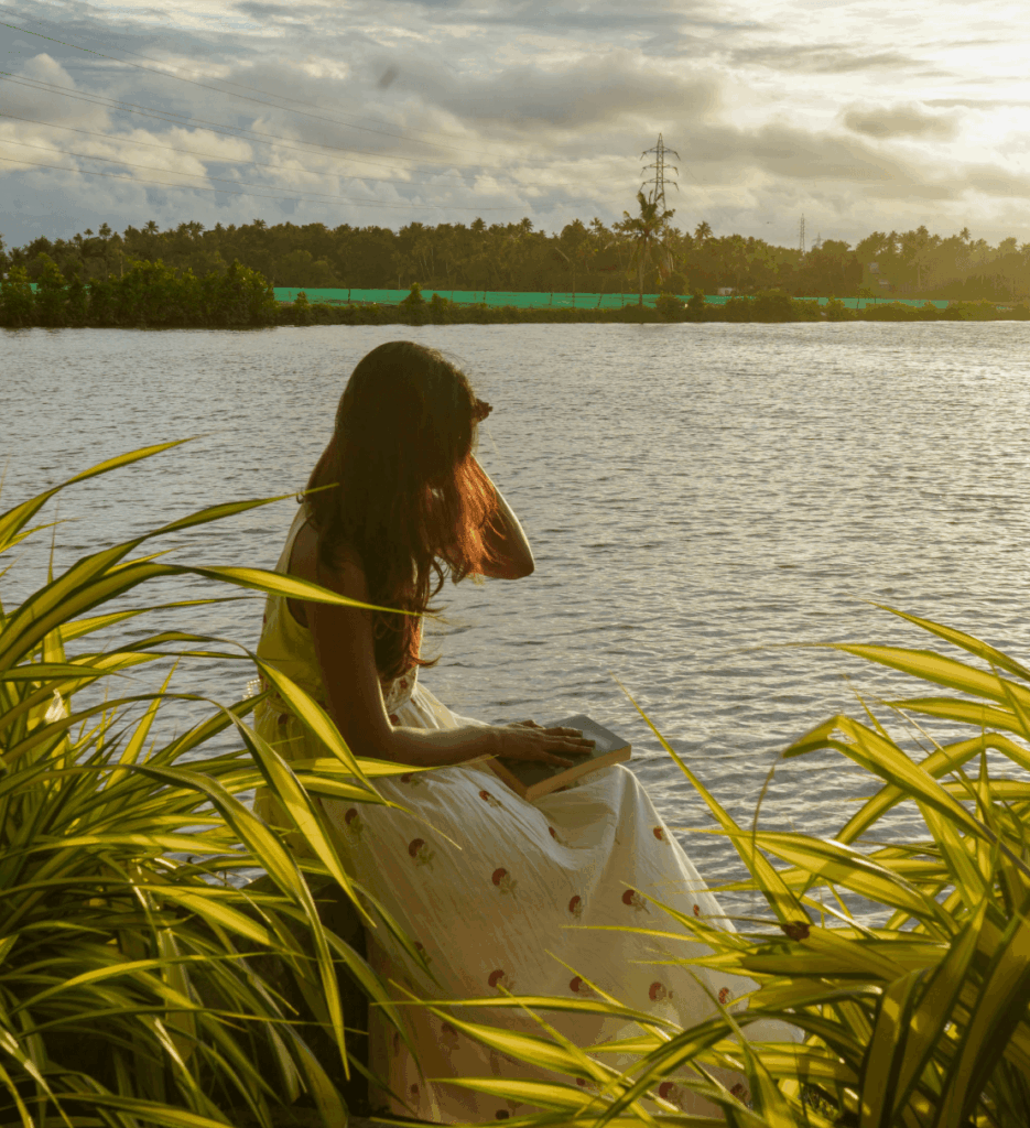 Guest sitting among the reeds watching the sunset at Giby Farm