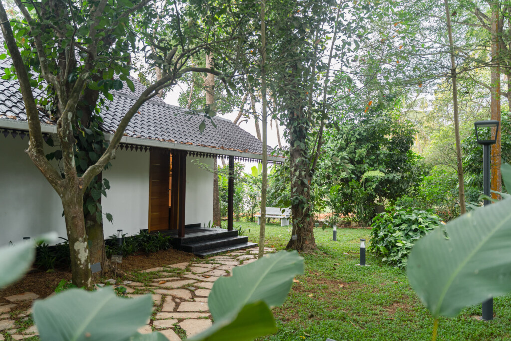 Cottage entrance at Giby Farm framed by tropical plants