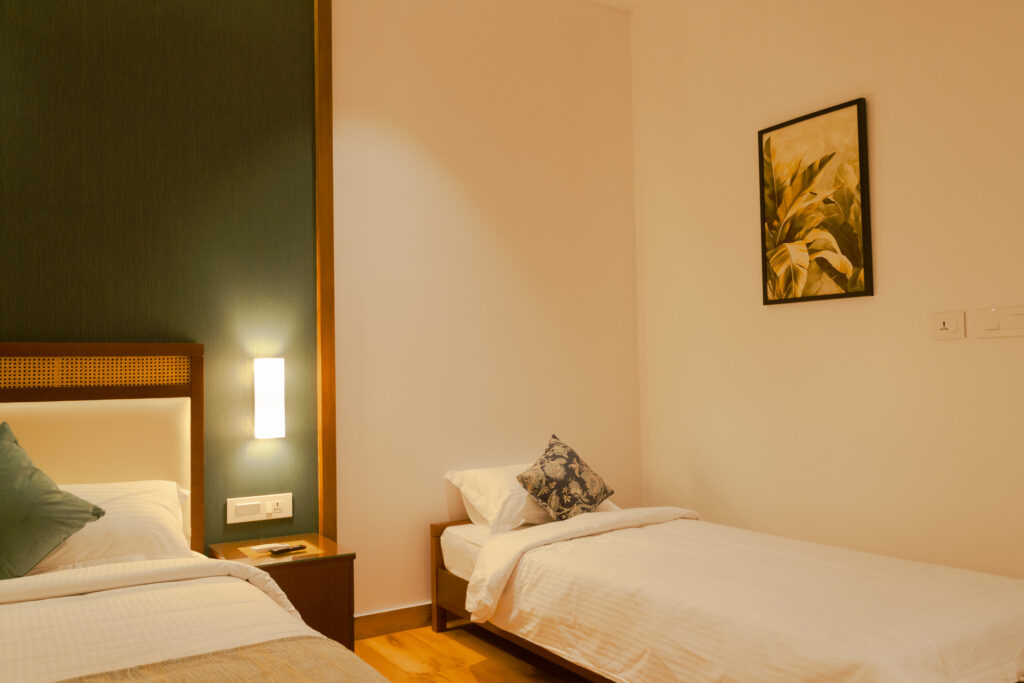Twin bedded room at Giby Farm with warm lighting and wooden furniture