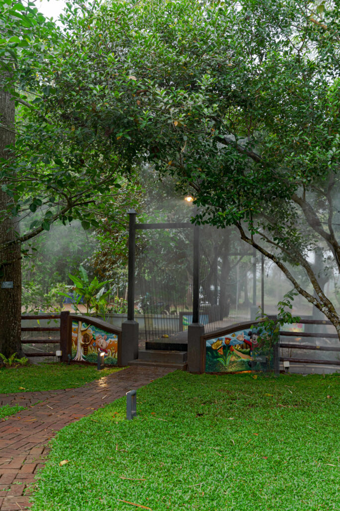 Shaded seating area under the star trees at Nakshatra Vanam, Giby Farm