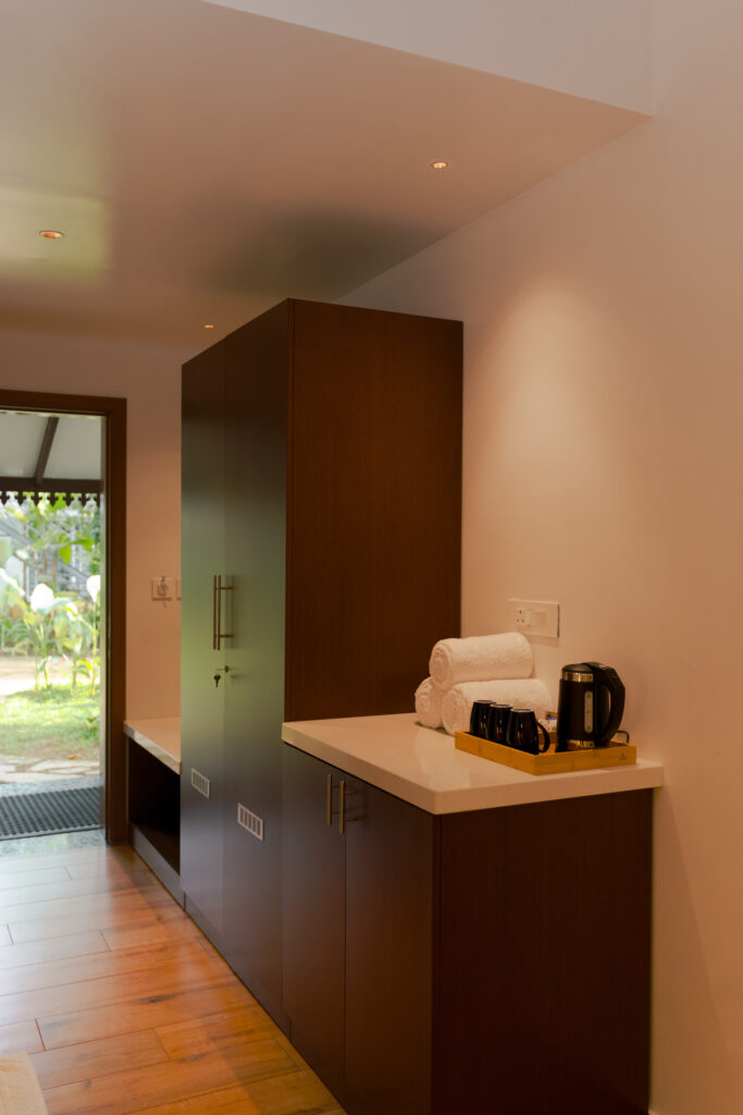 Pantry corner with a kettle and wooden cabinet in a Giby Farm villa room