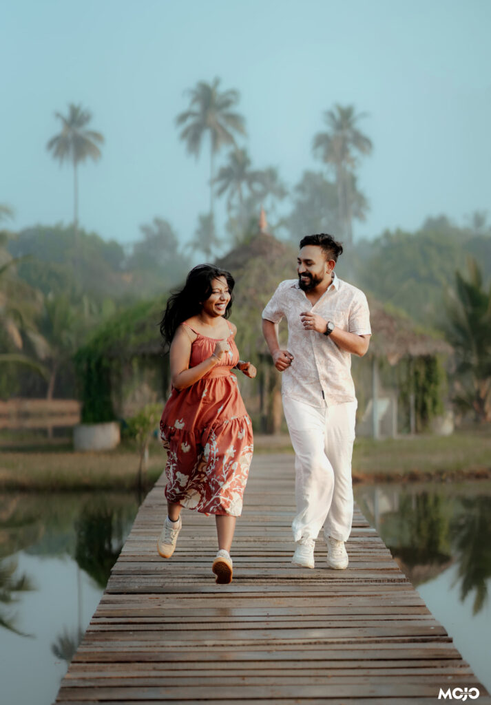 Couple walking along the wooden bridge over the backwater at Giby Farm