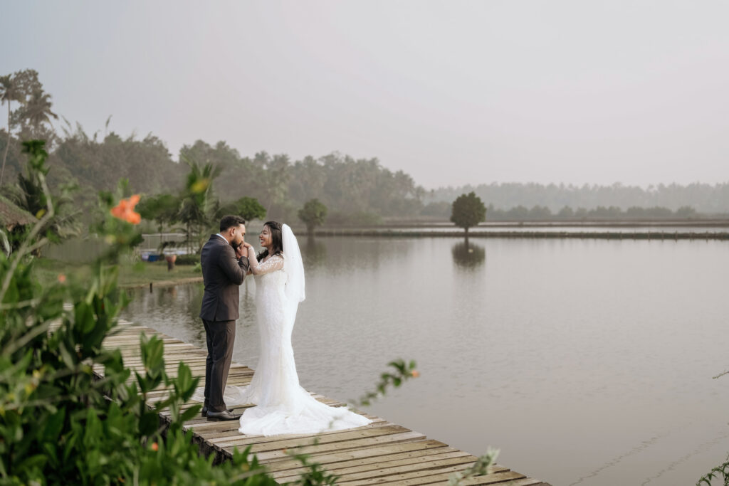 Newly married couple photographed by the water at Giby Farm