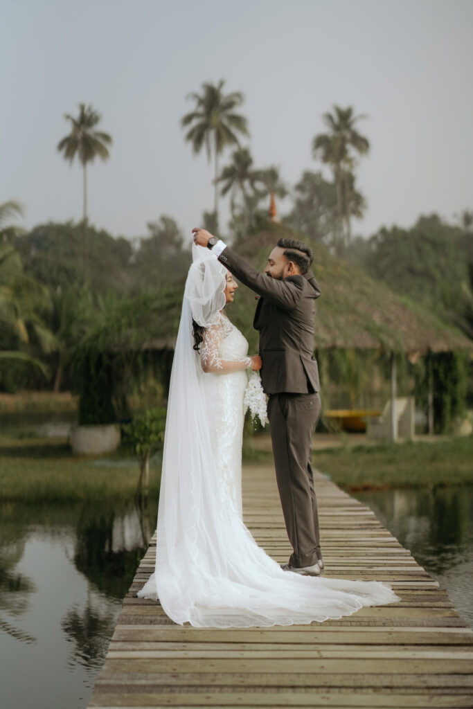Bride and groom photographed on the jetty framed by coconut palms at Giby Farm