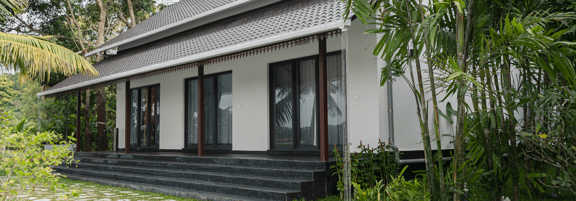 Modern villa at Giby Farm surrounded by trees and garden planting