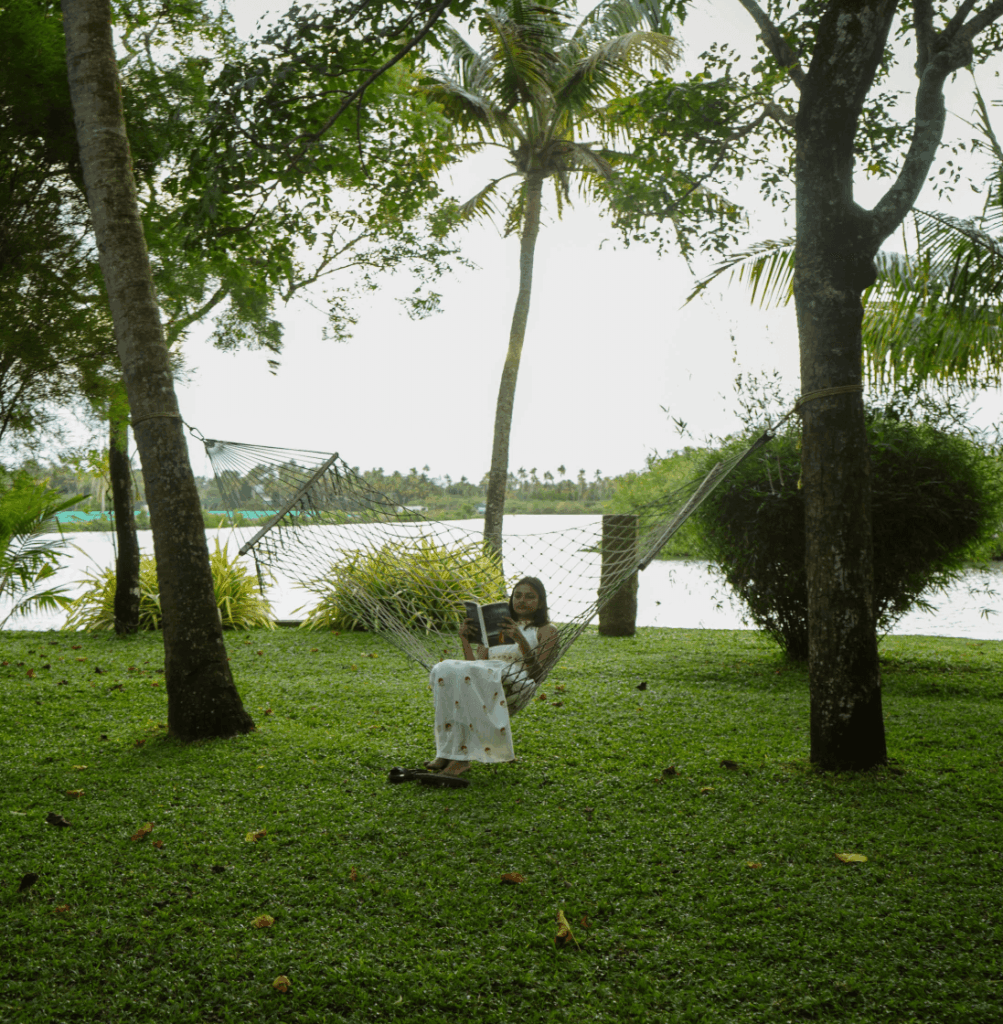 Quiet lawn and seating by the backwater at Giby Farm