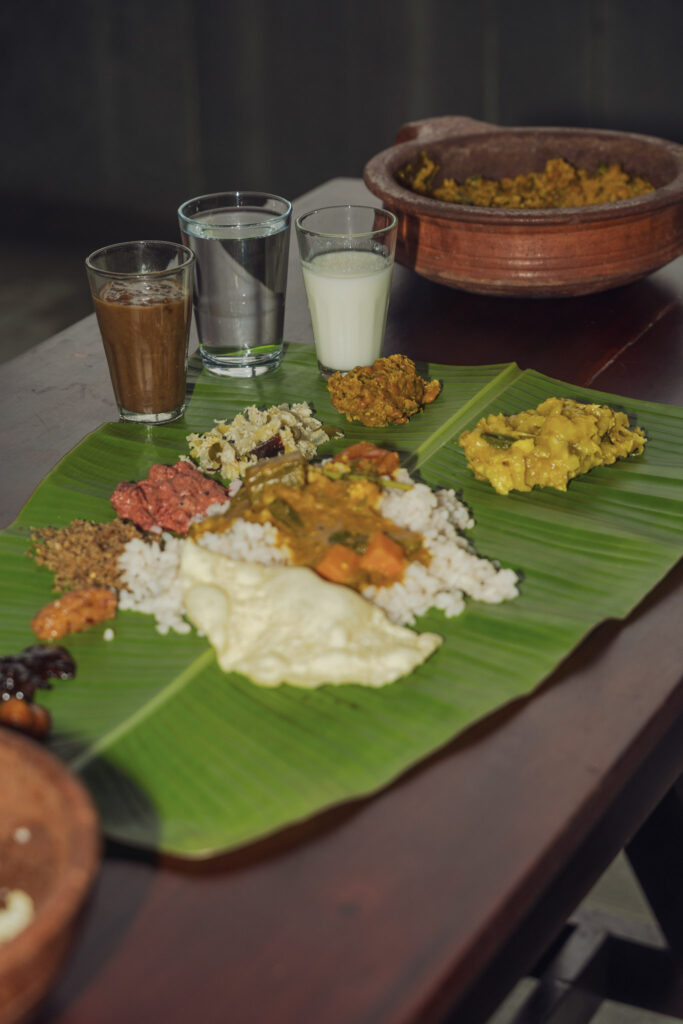 Traditional Kerala sadya served on a banana leaf at Giby Farm